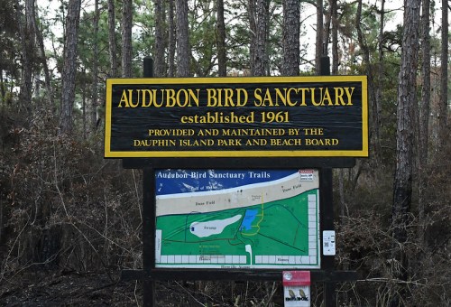 Sign for Audubon Bird Sanctuary, established in 1961, with a map of the trails and surrounding nature.