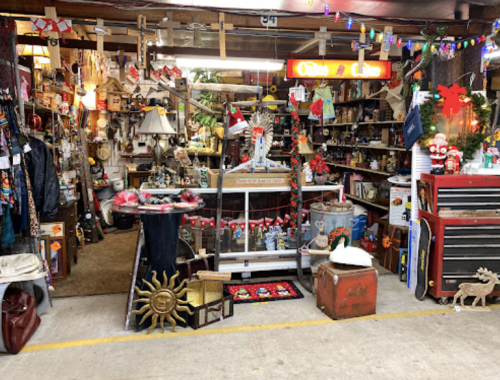 A cozy antique shop filled with various vintage items, decorations, and holiday ornaments.
