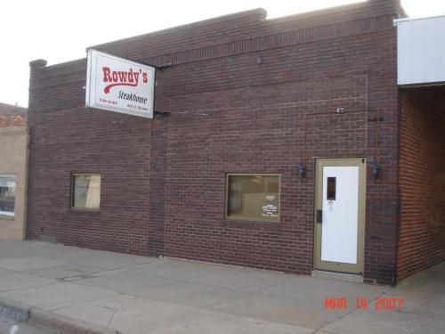 Exterior of Rowdy's Steakhouse, a brick building with a sign, windows, and a door, dated March 14, 2007.
