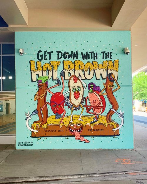 Colorful mural featuring quirky characters promoting "Get Down with the Hot Brown!" with playful illustrations and vibrant colors.