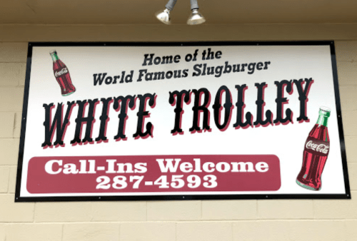 Sign for White Trolley, home of the World Famous Slugburger. Call-ins welcome, phone number 287-4593.
