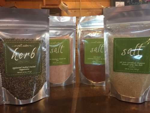 Four bags of seasoning: herb, salt, and two types of salt, all in clear pouches with green labels.