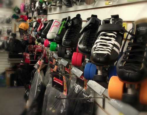 A display of various roller skates and accessories hanging on a wall in a skate shop.