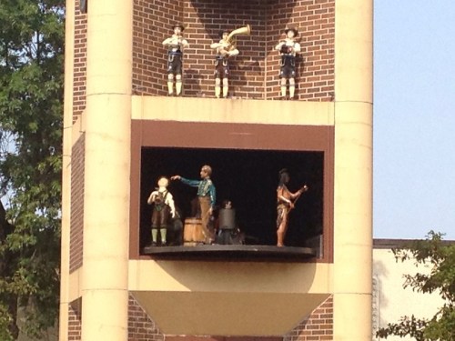 A bell tower featuring animated figures playing instruments and performing on a balcony.