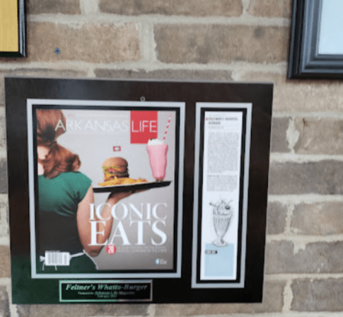 Magazine cover featuring a woman with a burger and milkshake, titled "Arkansas Life: Iconic Eats."