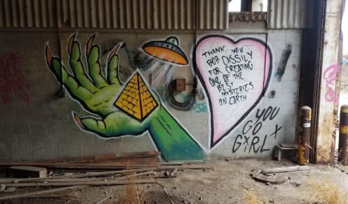 Graffiti featuring a green alien hand, pyramids, and a heart with a message of gratitude and encouragement.
