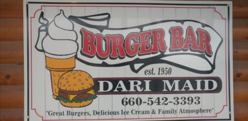 Sign for Burger Bar Dari Maid featuring a burger, ice cream, and text promoting great food and family atmosphere.