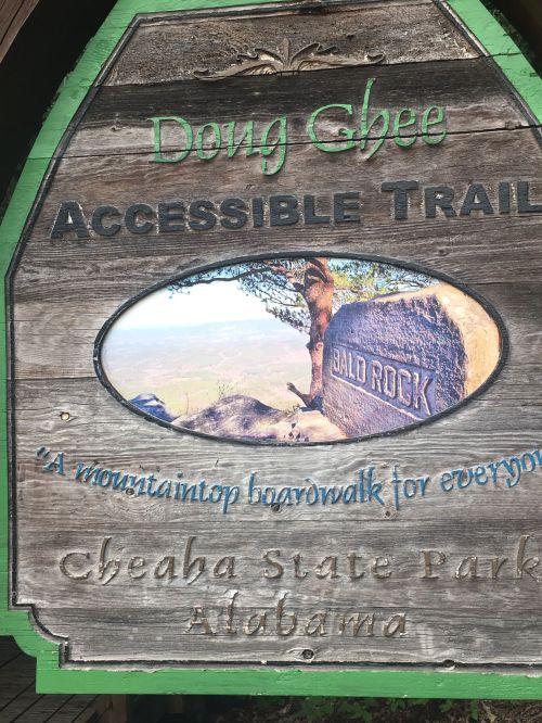 Sign for Dong Ghee Accessible Trail at Cheaha State Park, featuring a view of Bald Rock and a wooden boardwalk.