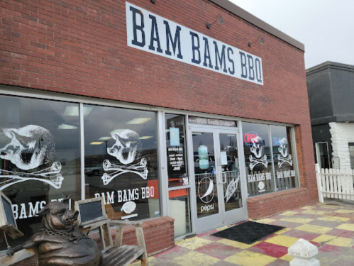 Exterior of Bam Bam's BBQ featuring a brick facade, large signage, and a colorful tiled entrance.