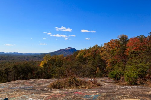 Scenic view of a mountain landscape with colorful autumn foliage under a clear blue sky.