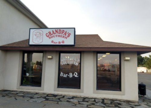 Exterior of Grandpa's Southern Bar-B-Q restaurant, featuring a sign and large windows with the restaurant's name.