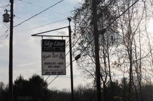 Sign for Skyline Drive-In featuring "Hank's Last Stop" with menu items like burgers, BBQ, and hot dogs.