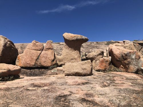 A rocky landscape with various stone formations under a clear blue sky.