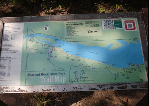 Trail map of Starved Rock State Park, showing trails, landmarks, and a warning to call 911 in emergencies.