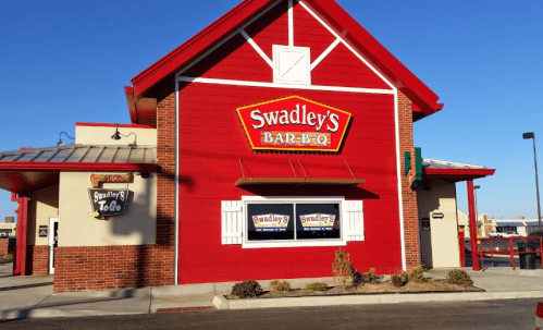 Exterior of Swadley's Bar-B-Q restaurant, featuring a red building with a peaked roof and large signage.
