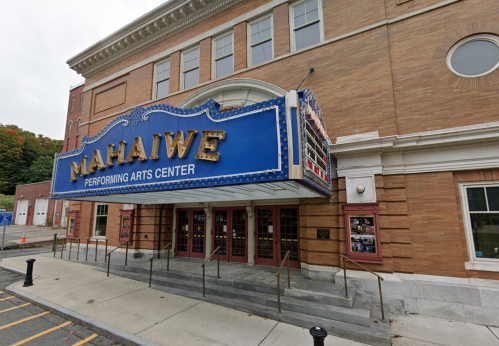 Exterior of the Mahaiwe Performing Arts Center, featuring a blue marquee and steps leading to the entrance.