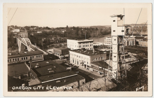 A vintage postcard showing the Oregon City Elevator and surrounding buildings, with a bridge and river in the background.