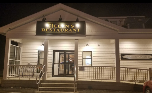 Exterior of Ellen's Restaurant at night, featuring a white facade and illuminated sign.