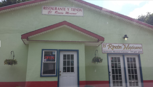 Colorful exterior of a Mexican restaurant and store, featuring "Open" sign and decorative hanging plants.