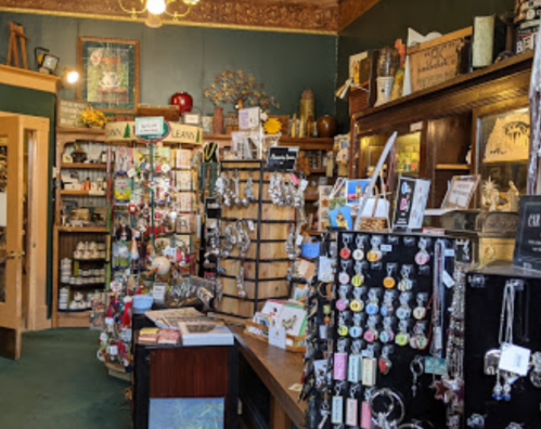 A cozy shop interior filled with various crafts, jewelry, and decorative items on display.