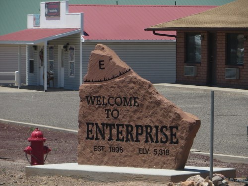 A large rock sign reading "Welcome to Enterprise" with establishment year 1896 and elevation 5,318 feet.
