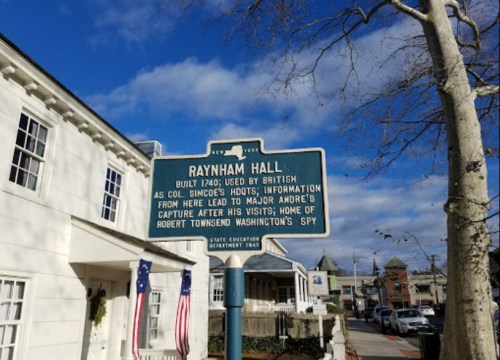 Historical sign for Raynham Hall, detailing its use by British troops and notable events from the 1700s.