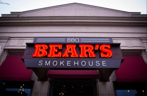 Sign for Bear's Smokehouse BBQ, featuring bold red letters against a dark background.