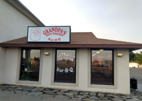 Exterior of Grandpa's Southern Bar-B-Q restaurant, featuring a sign and large windows with the restaurant's name.