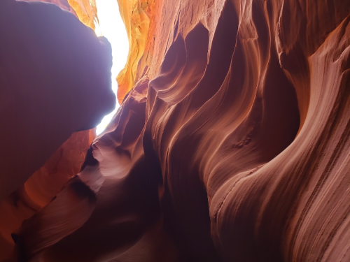 A stunning view of Antelope Canyon, showcasing smooth, wavy rock formations illuminated by natural light.