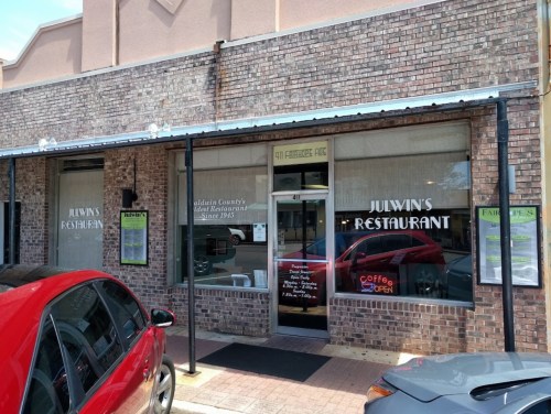 Exterior of Julwin's Restaurant, featuring brick facade, large windows, and a sign indicating it's open for business.