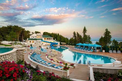 A serene poolside scene at a resort, surrounded by lush greenery and colorful flowers under a vibrant sky.