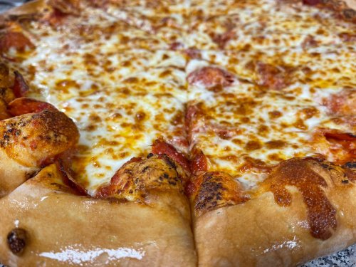 Close-up of a pepperoni pizza with melted cheese and a golden, crispy crust.