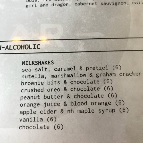 Menu listing of milkshakes: sea salt caramel, Nutella, brownie bits, peanut butter, orange, vanilla, and chocolate.
