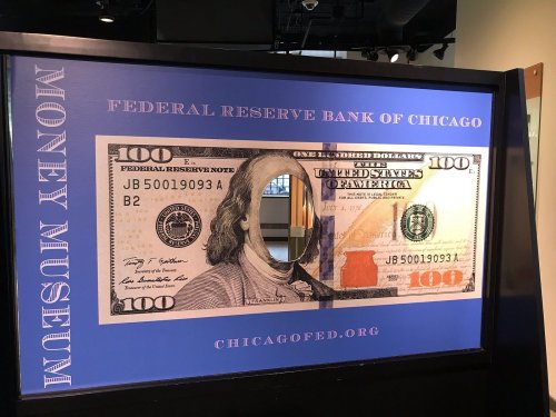 A large display of a $100 bill featuring George Washington at the Federal Reserve Bank of Chicago.