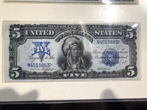 A vintage $5 silver certificate featuring a Native American chief illustration.