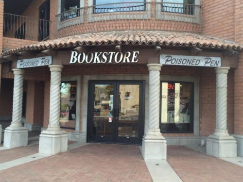 Exterior of a bookstore named "Poisoned Pen," featuring a welcoming entrance and decorative columns.