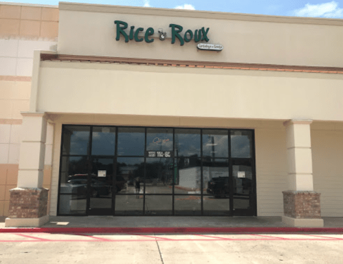 Exterior of a restaurant named "Rice & Roux," featuring large glass doors and a sign above.