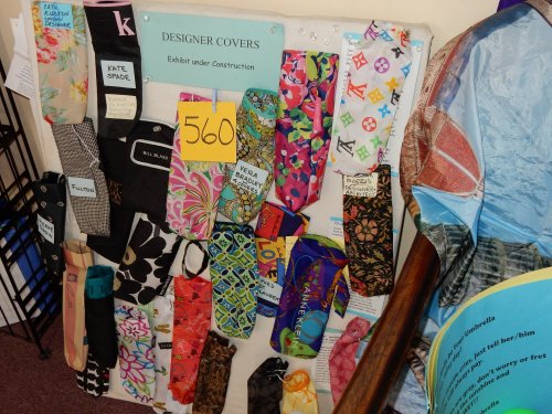 A display board featuring various designer covers in colorful patterns, labeled with numbers and names.