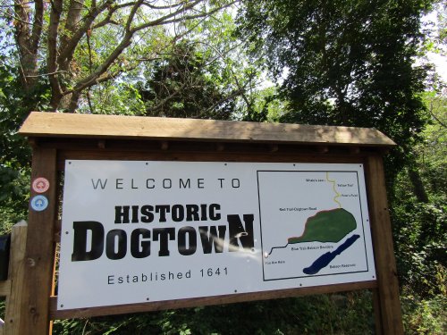 Sign welcoming visitors to Historic Dogtown, established in 1641, with a map of the area.