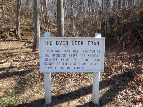 Sign for the Over-Look Trail, detailing a ½ mile path to a forest overlook with natural chimneys.
