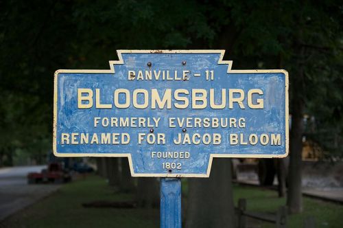 Sign for Bloomsburg, formerly Eversburg, named for Jacob Bloom, founded in 1802. Blue background with white text.