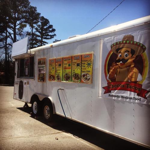 A food truck named "Checos Tacos" featuring a colorful menu of authentic Mexican dishes.