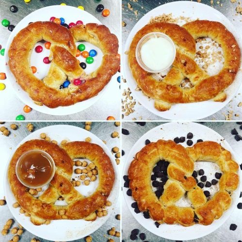 Four pretzels on plates, each with different toppings: candy, milk, caramel, and chocolate chips.
