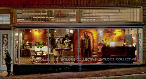 A storefront display featuring clothing and decor items, with "Taylor's Collective" prominently displayed.