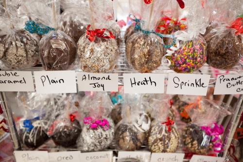 A display of assorted chocolate treats in clear bags, labeled with flavors like Almond Joy, Heath, and Peanut Butter Cup.