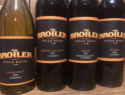Four wine bottles labeled "The Broiler Steak House" with varieties Chardonnay, Cabernet Sauvignon, Merlot, and Red Wine.