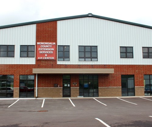 Exterior view of a two-story building with a sign for Monongalia County Extension Services & 4-H Center.