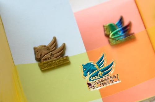 Three colorful pins featuring winged horse designs, labeled "2021" and "Pegasus Festival."