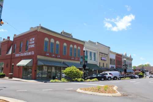 A charming street view of historic buildings with shops and a blue sky in a small town.