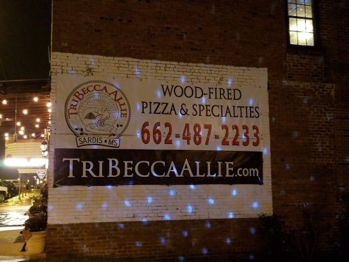 Sign for TriBecca Allie, a wood-fired pizza restaurant in Sardis, MS, featuring contact info and website.